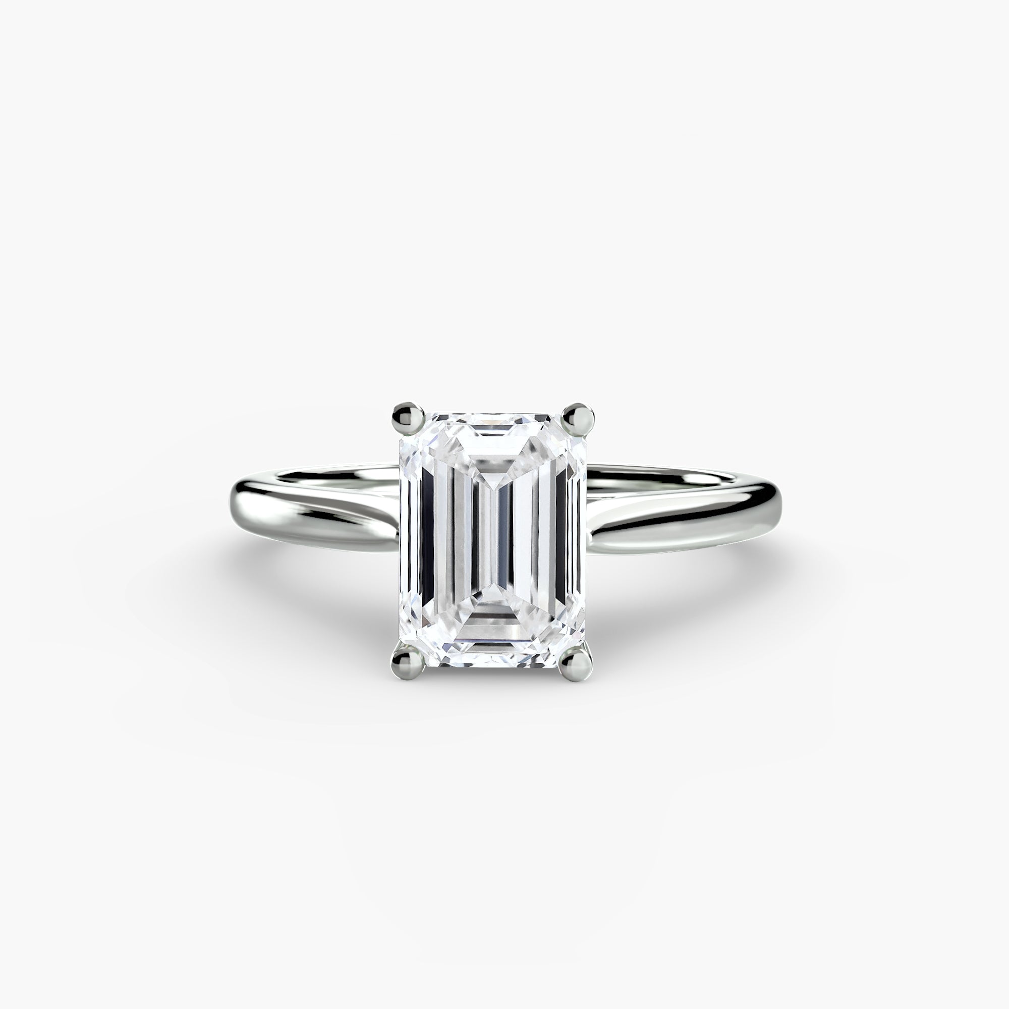Diamond ring with emerald-cut gemstone on a white background