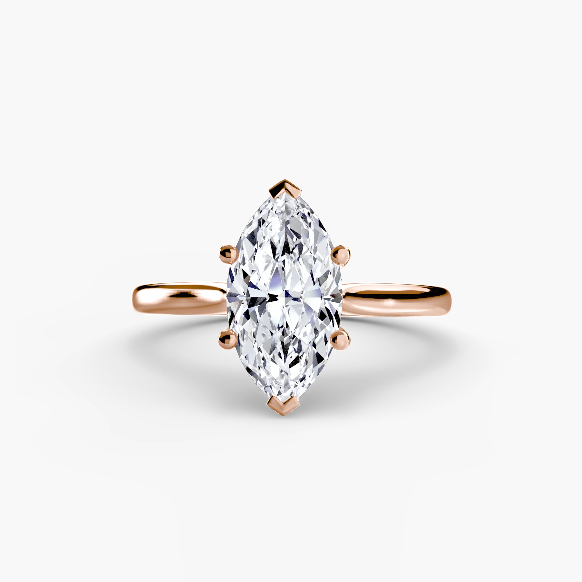 Rose gold ring with a pear-shaped diamond on a white background