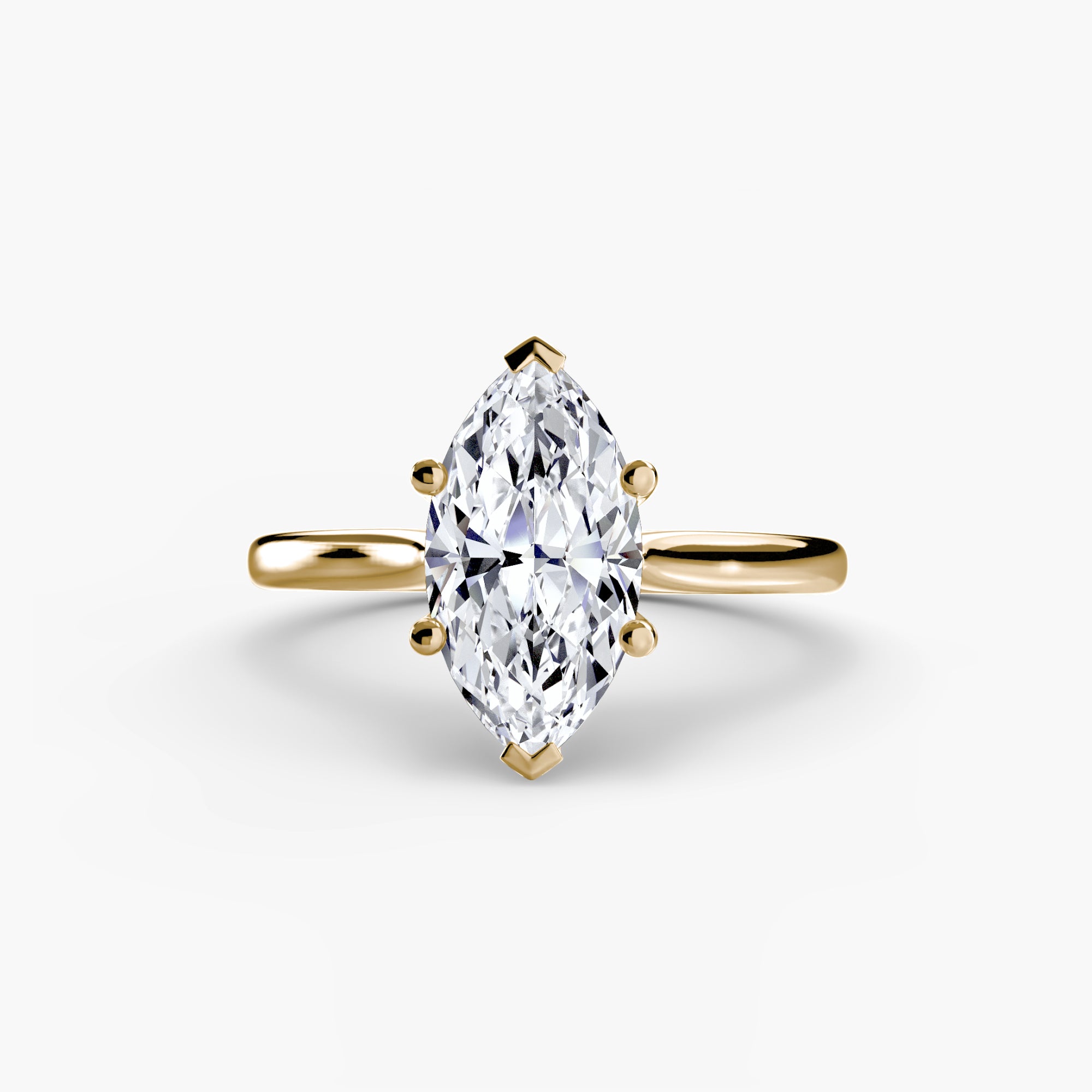 Gold ring with a marquise-shaped diamond on a white background