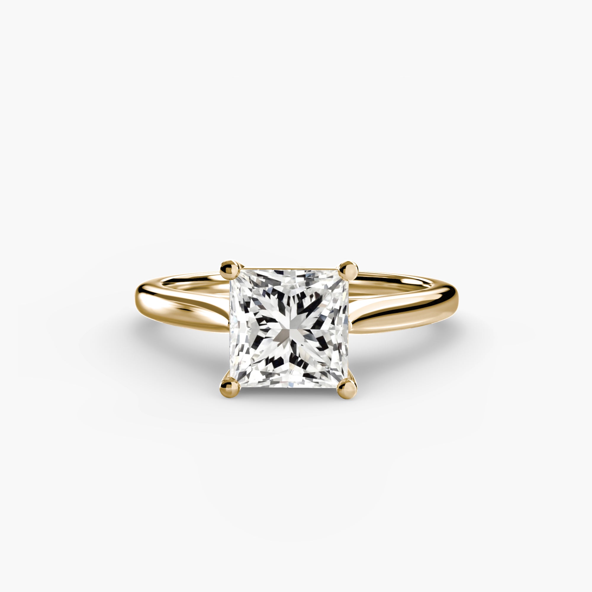 Gold ring with a large diamond on a white background